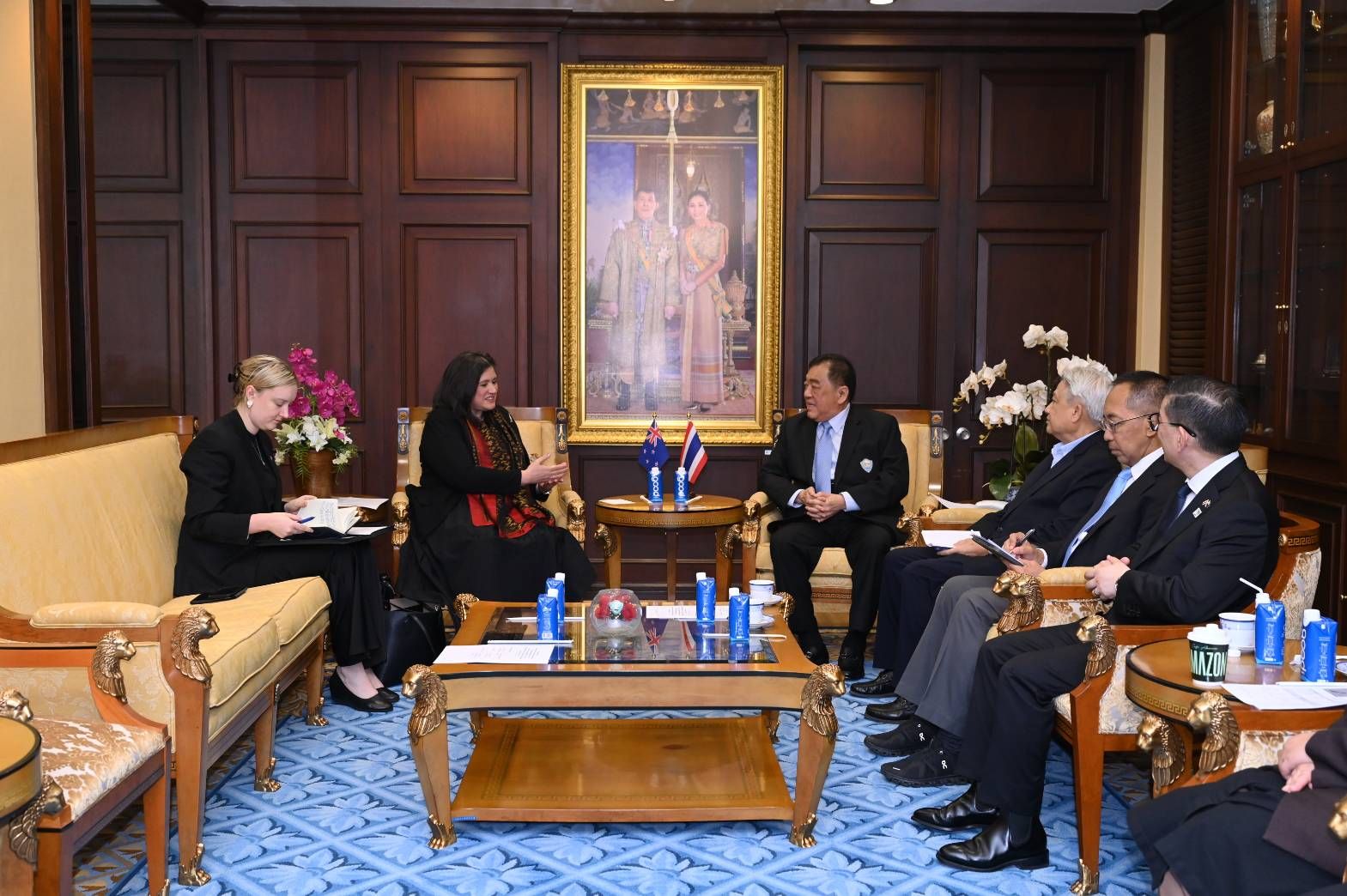 Officials meet in a formal room with dark wood paneling and ornate furniture.