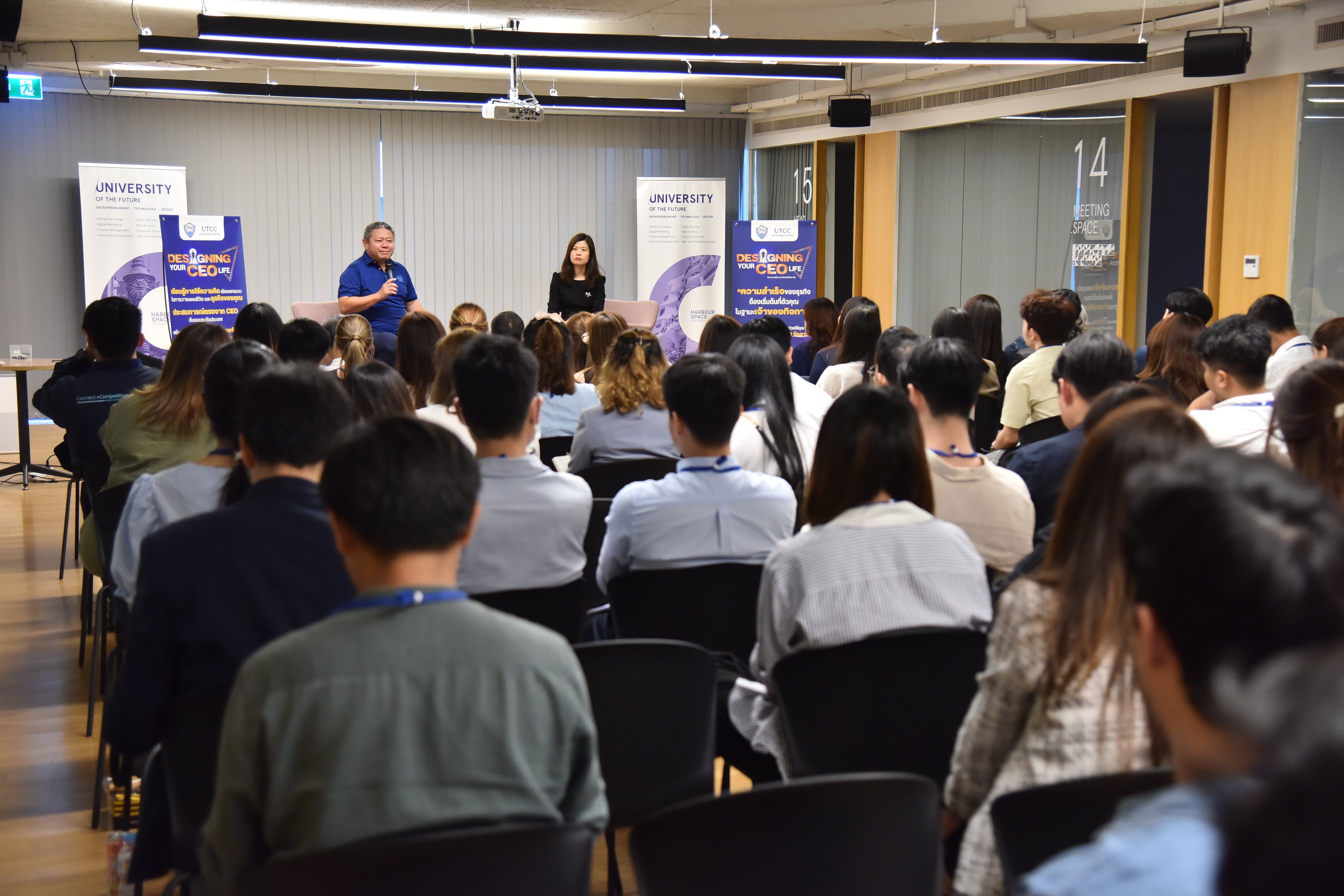 Audience listens to two speakers at a professional presentation event.