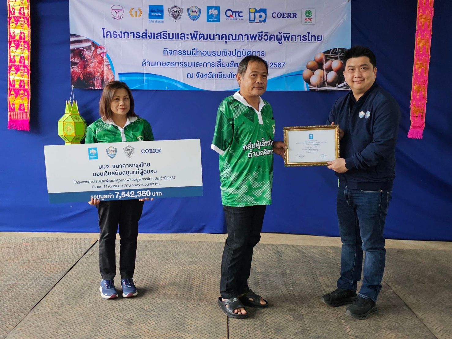 Man receives an award from another, while a woman holds a large check.