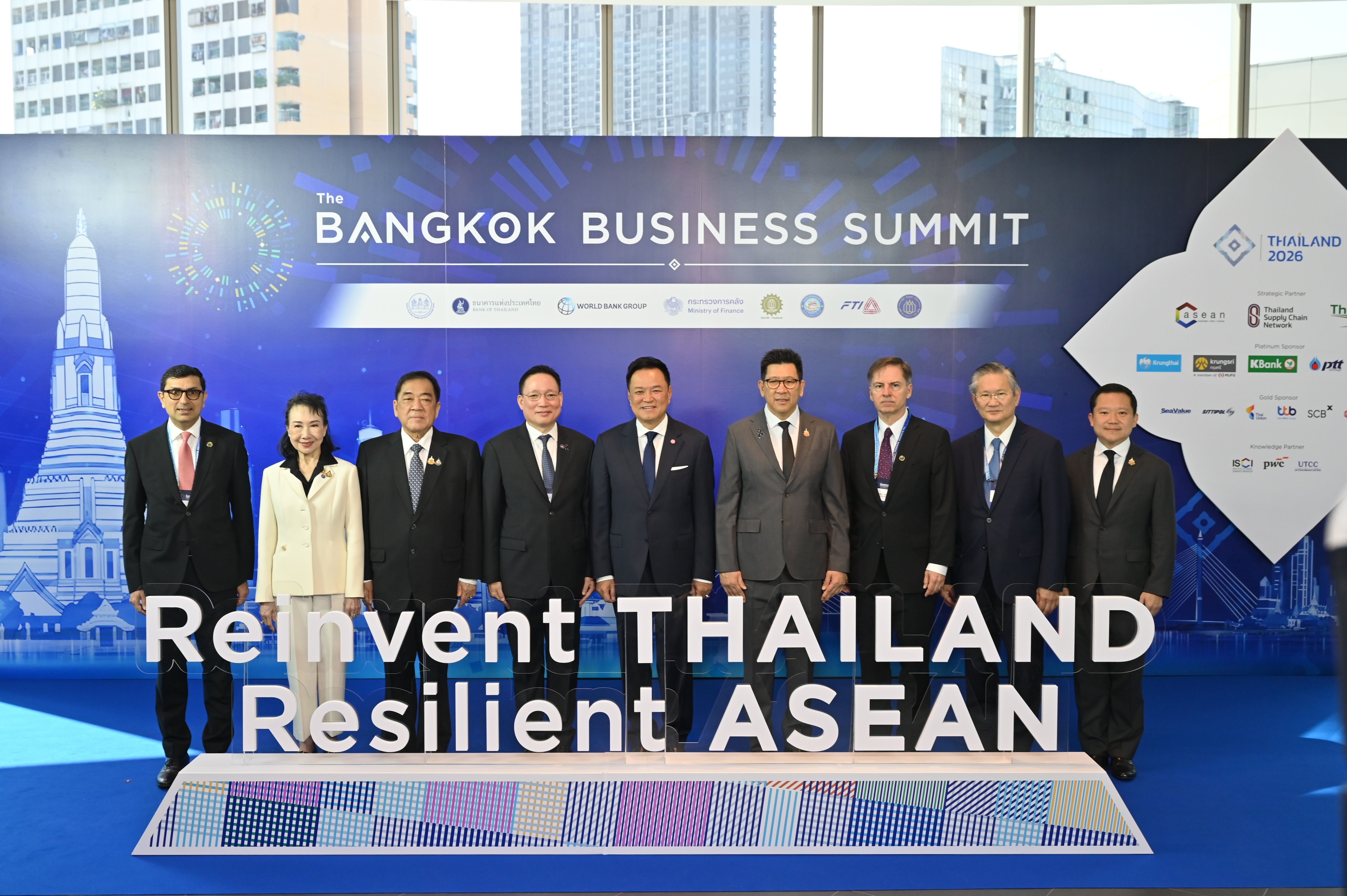 Nine leaders stand before the 'Reinvent THAILAND Resilient ASEAN' sign at a summit.