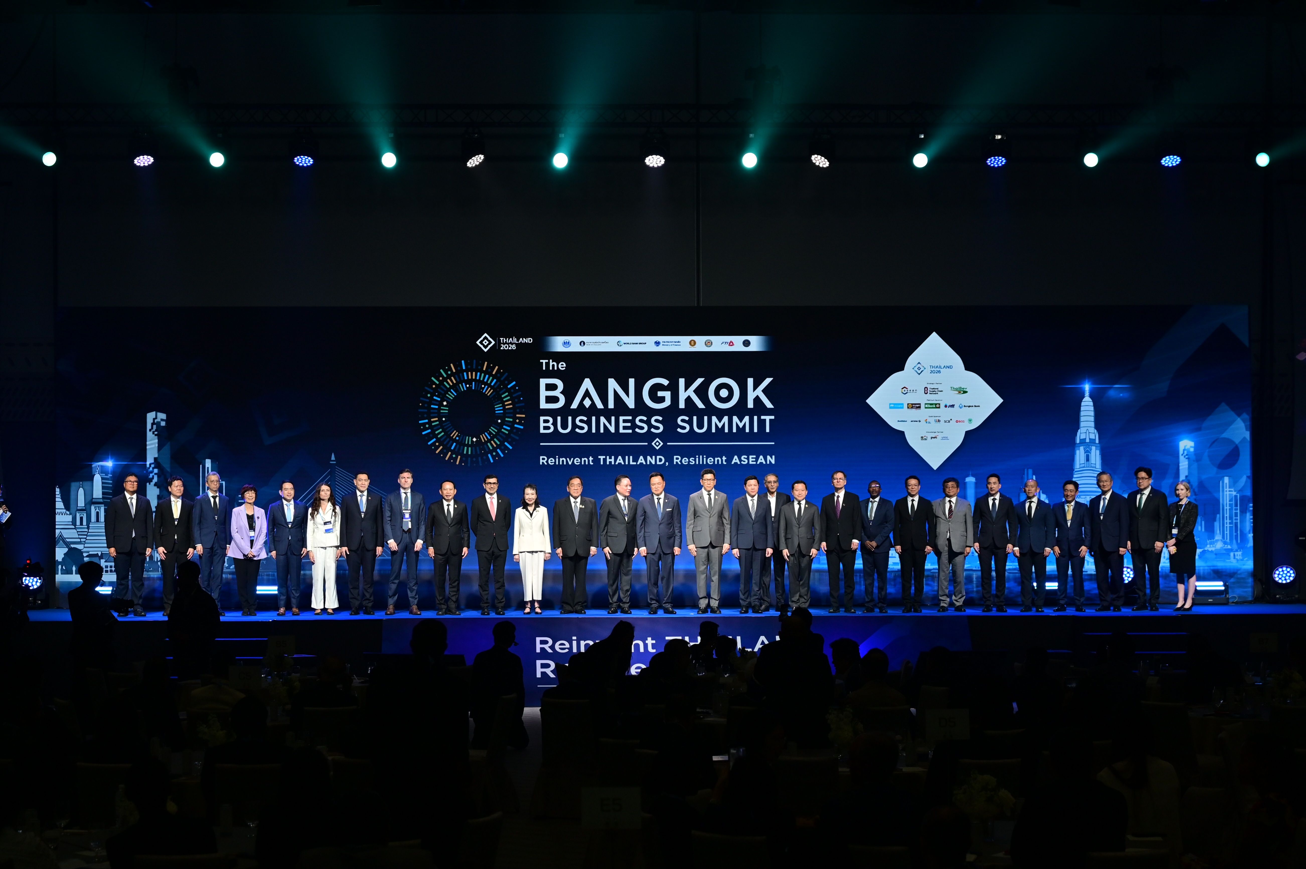 Group of business leaders standing on stage at The Bangkok Business Summit event.