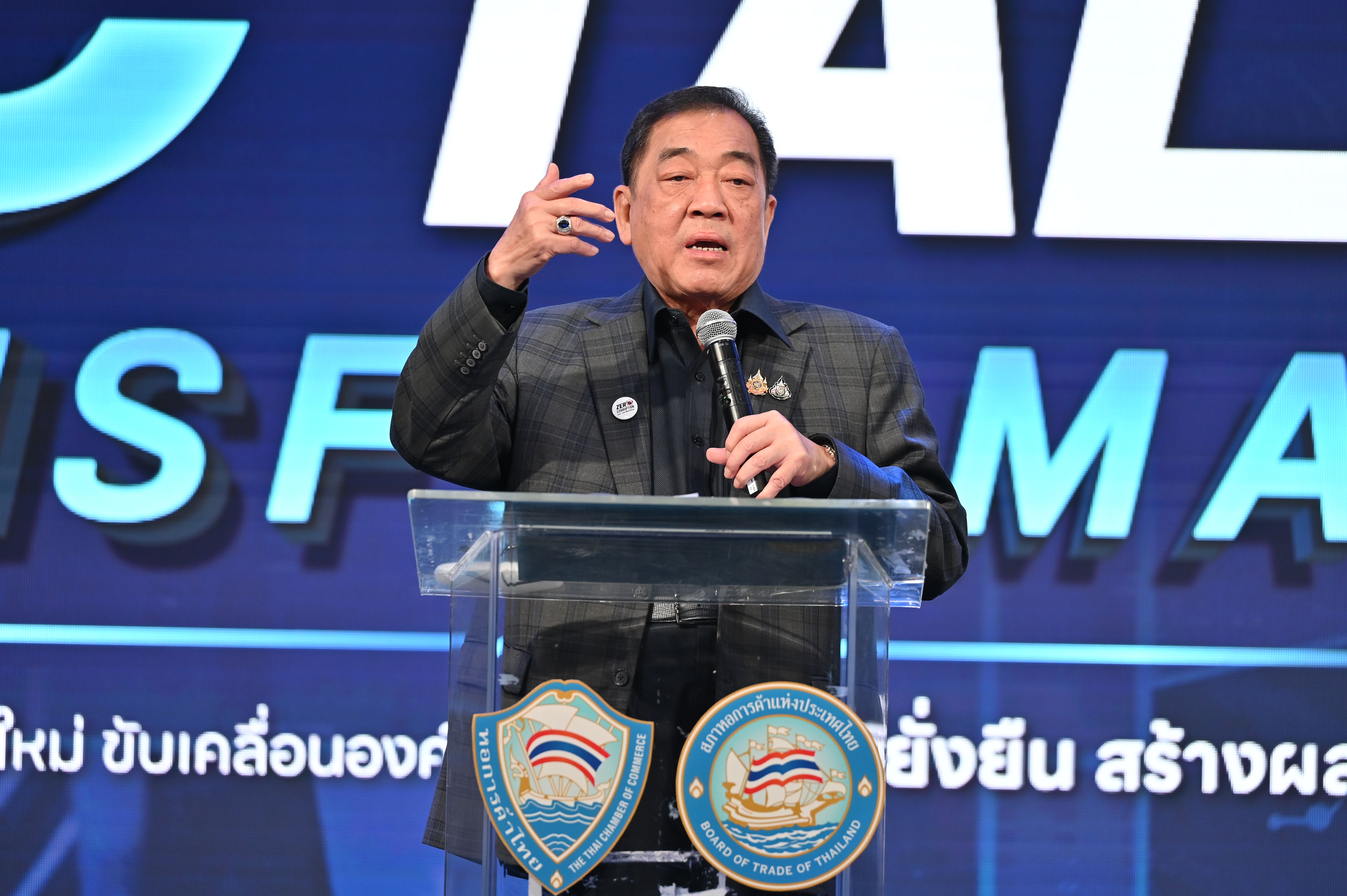 Man in suit speaks passionately at a podium, gesturing with his hand.