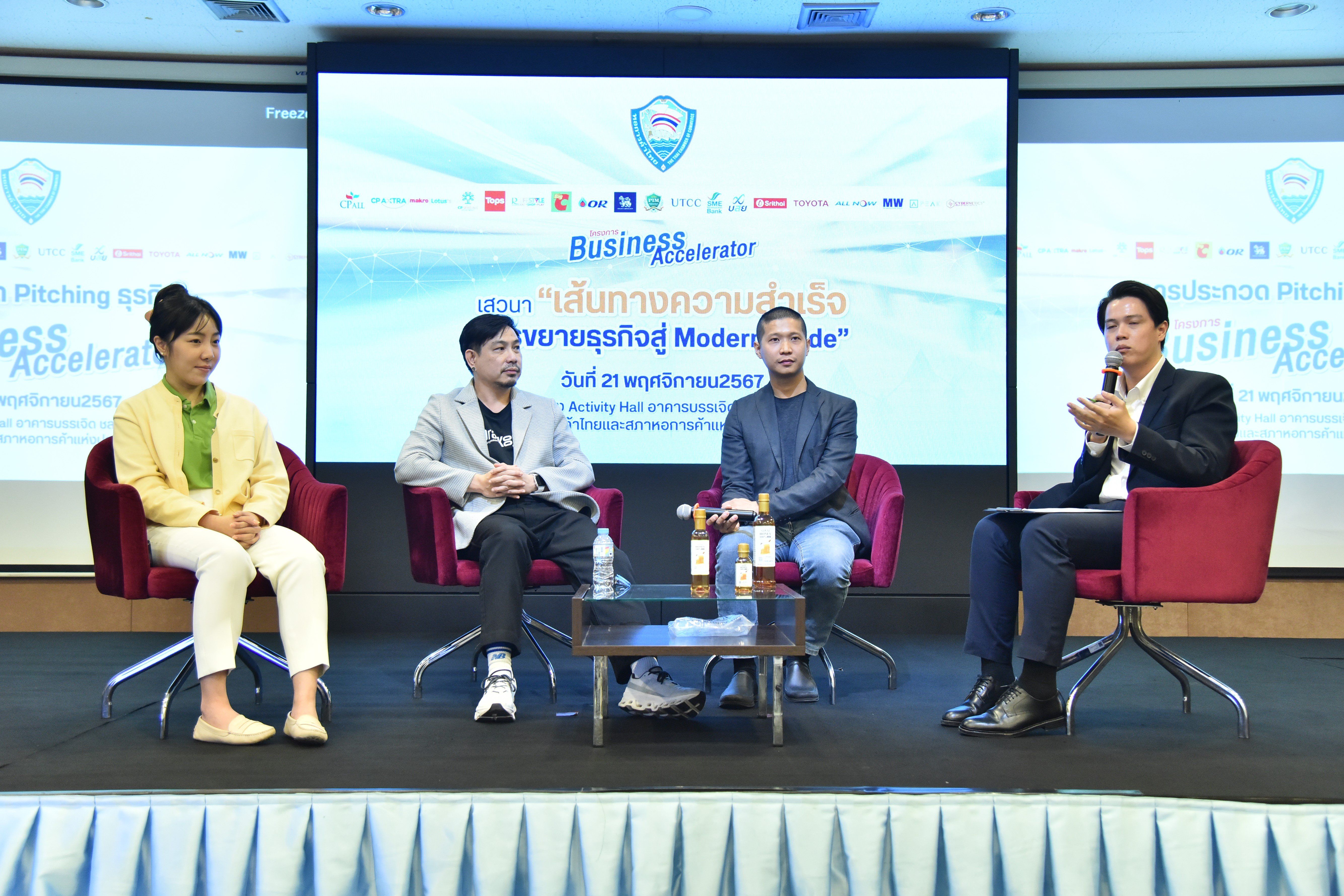Four people on stage participating in a panel discussion at a Business Accelerator event.