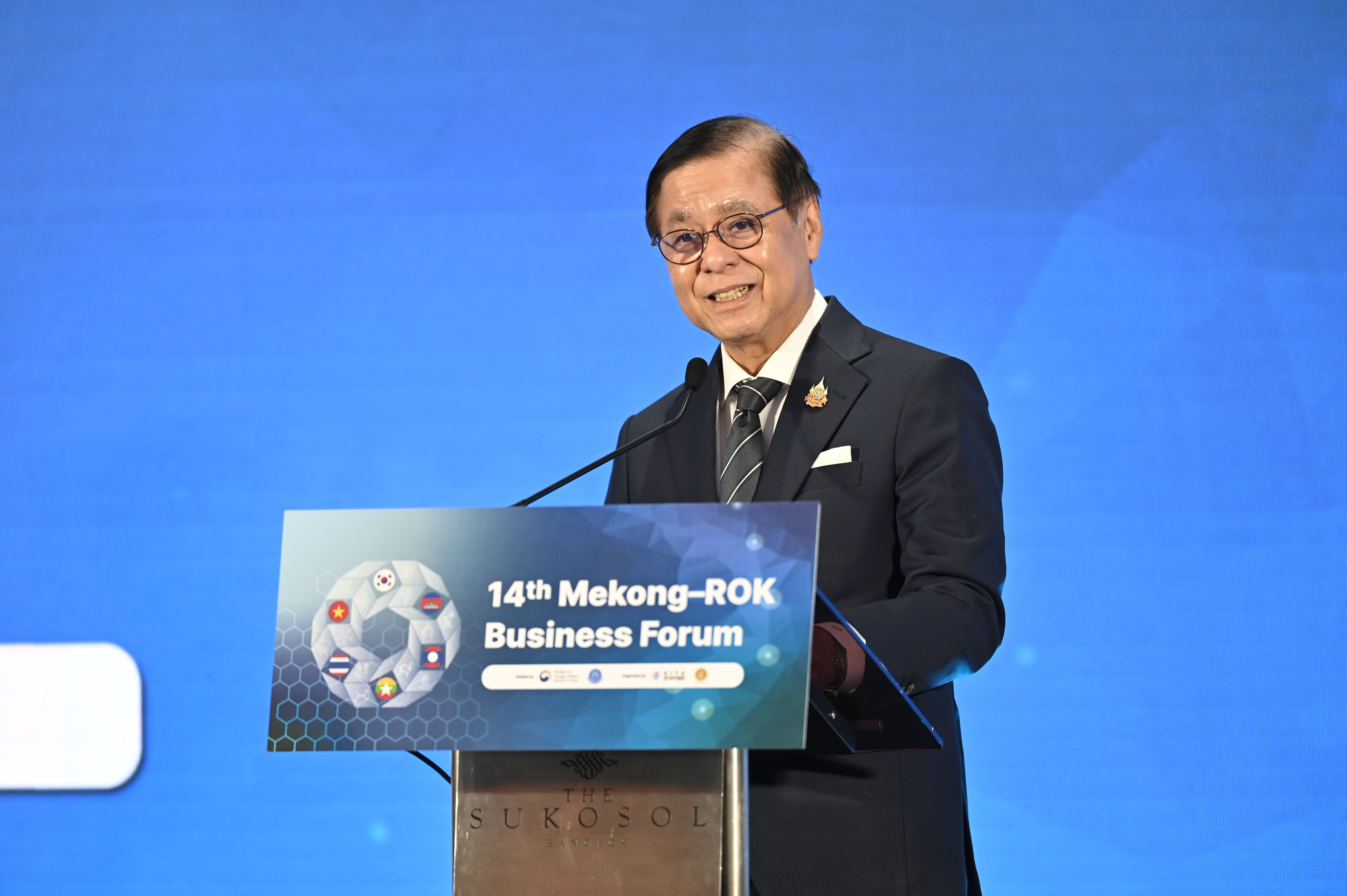 A man in a suit speaks at a podium during the 14th Mekong-ROK Business Forum.