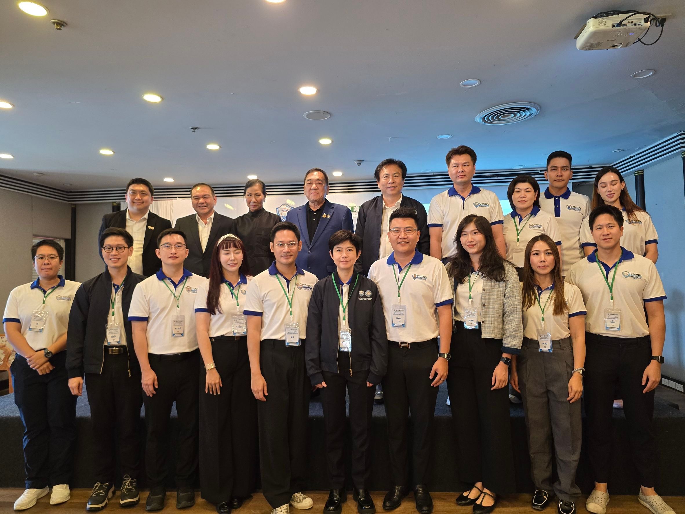 A large group of diverse professionals smiling for a photo at an indoor event.