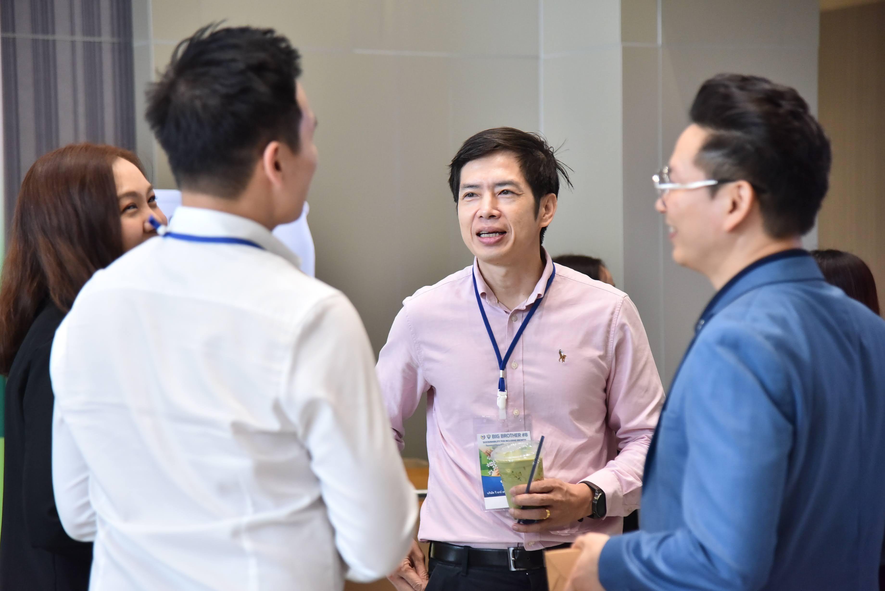 Three professionals engaging in a lively discussion at a conference event.