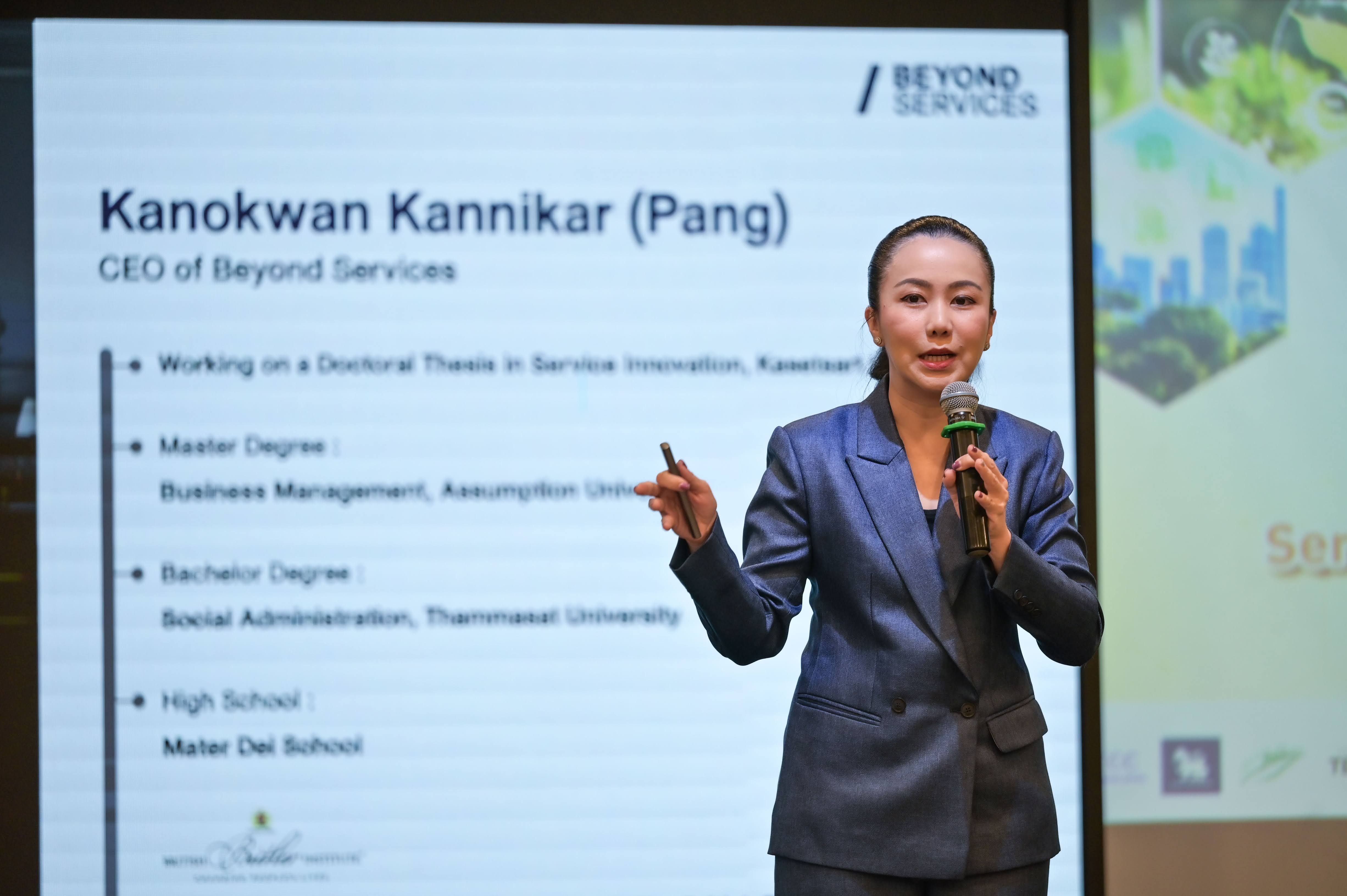Kanokwan Kannikar, CEO of Beyond Services, presents with a slide detailing her professional background.