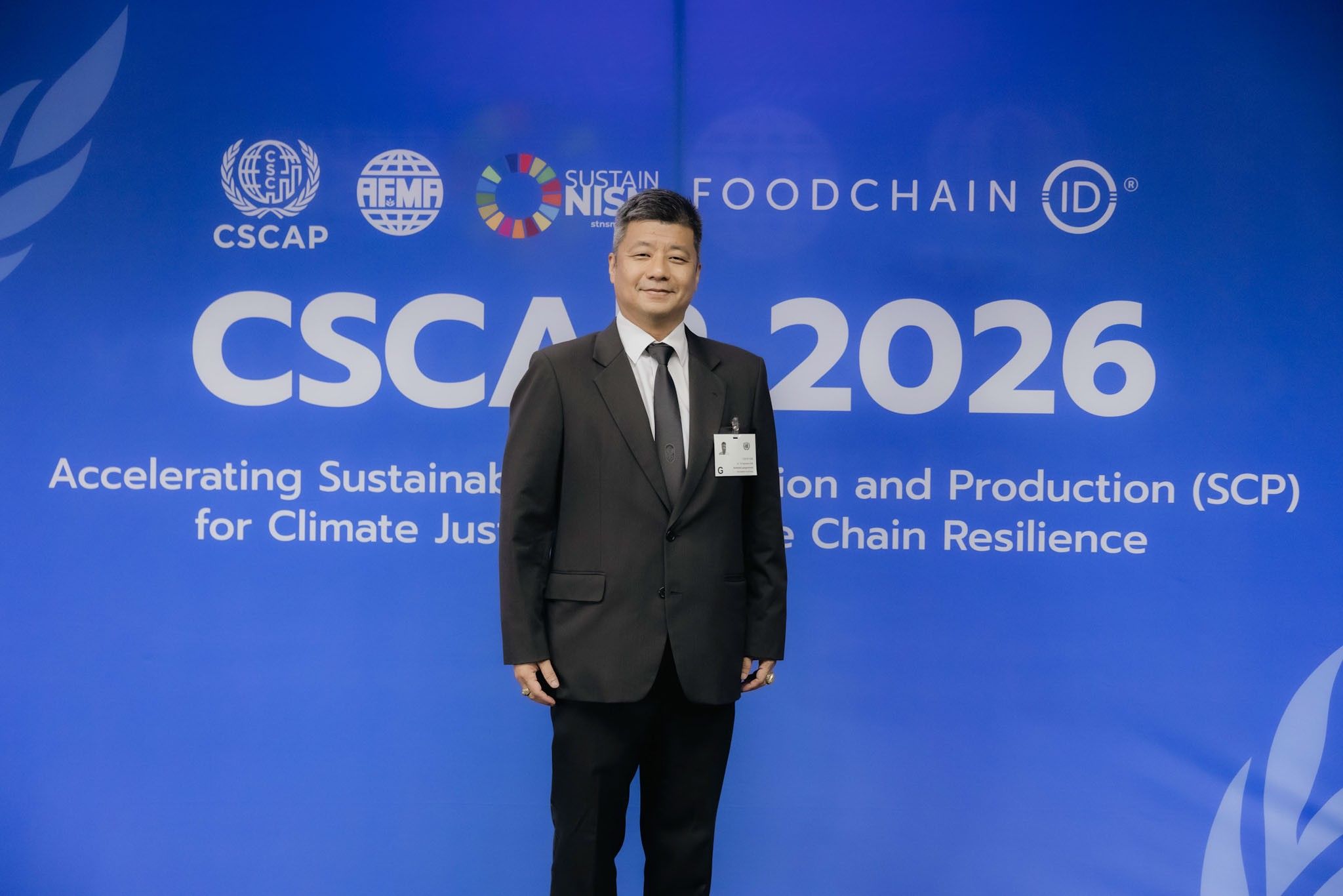 Man in suit stands before a blue backdrop with "CSCA 2026" and event logos.