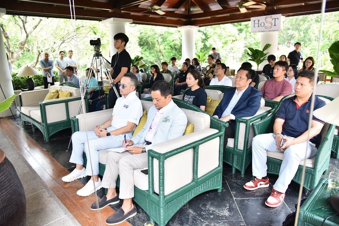 Group of men and women attending an event in a luxurious outdoor lounge setting.