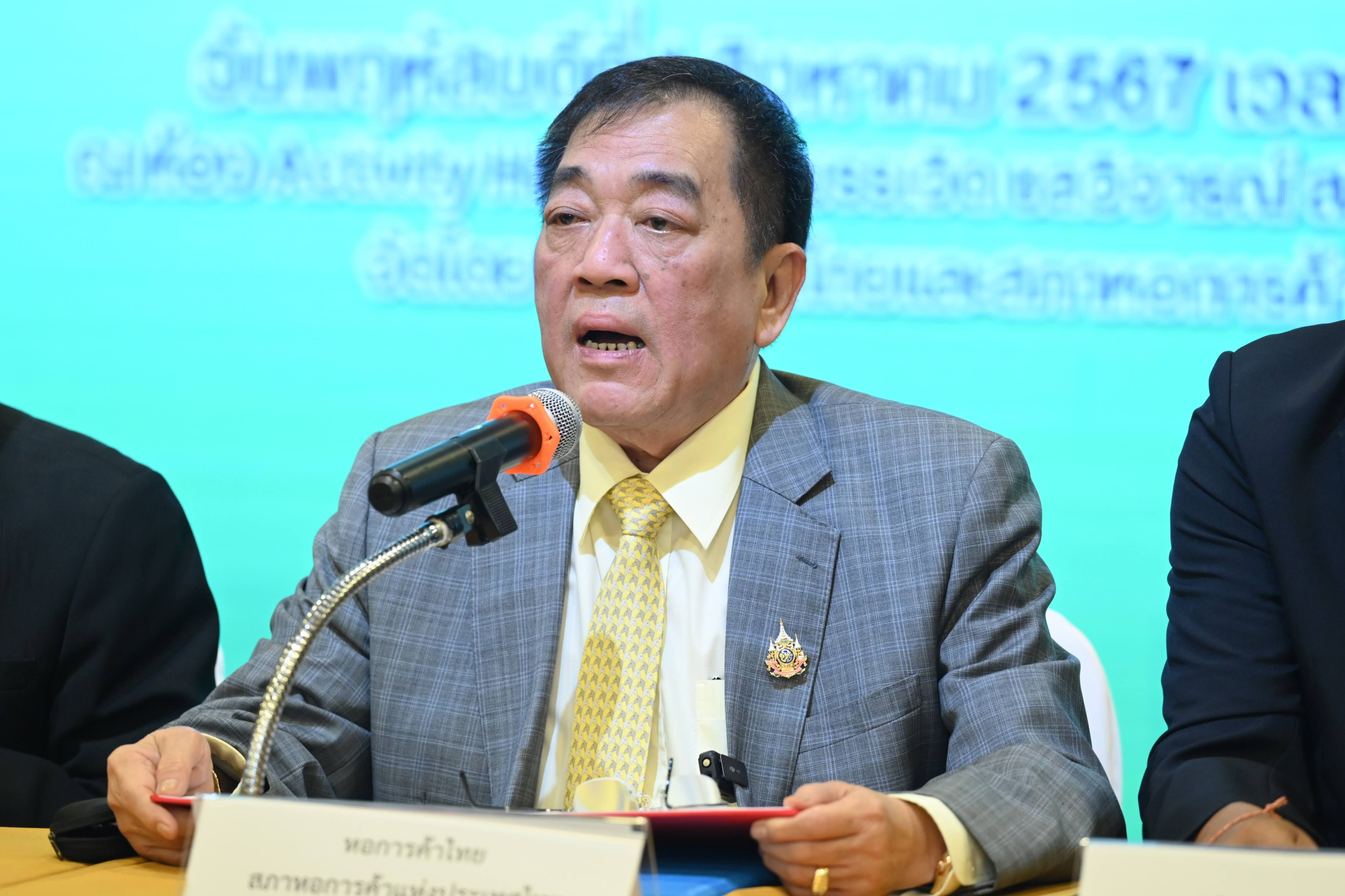 Asian man in grey suit speaks at microphone during a press conference.
