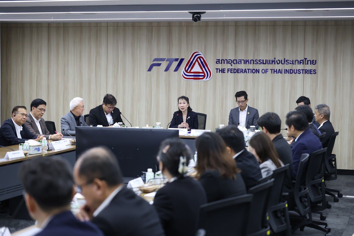 A group of professionals meets at a conference table, with The Federation of Thai Industries logo.