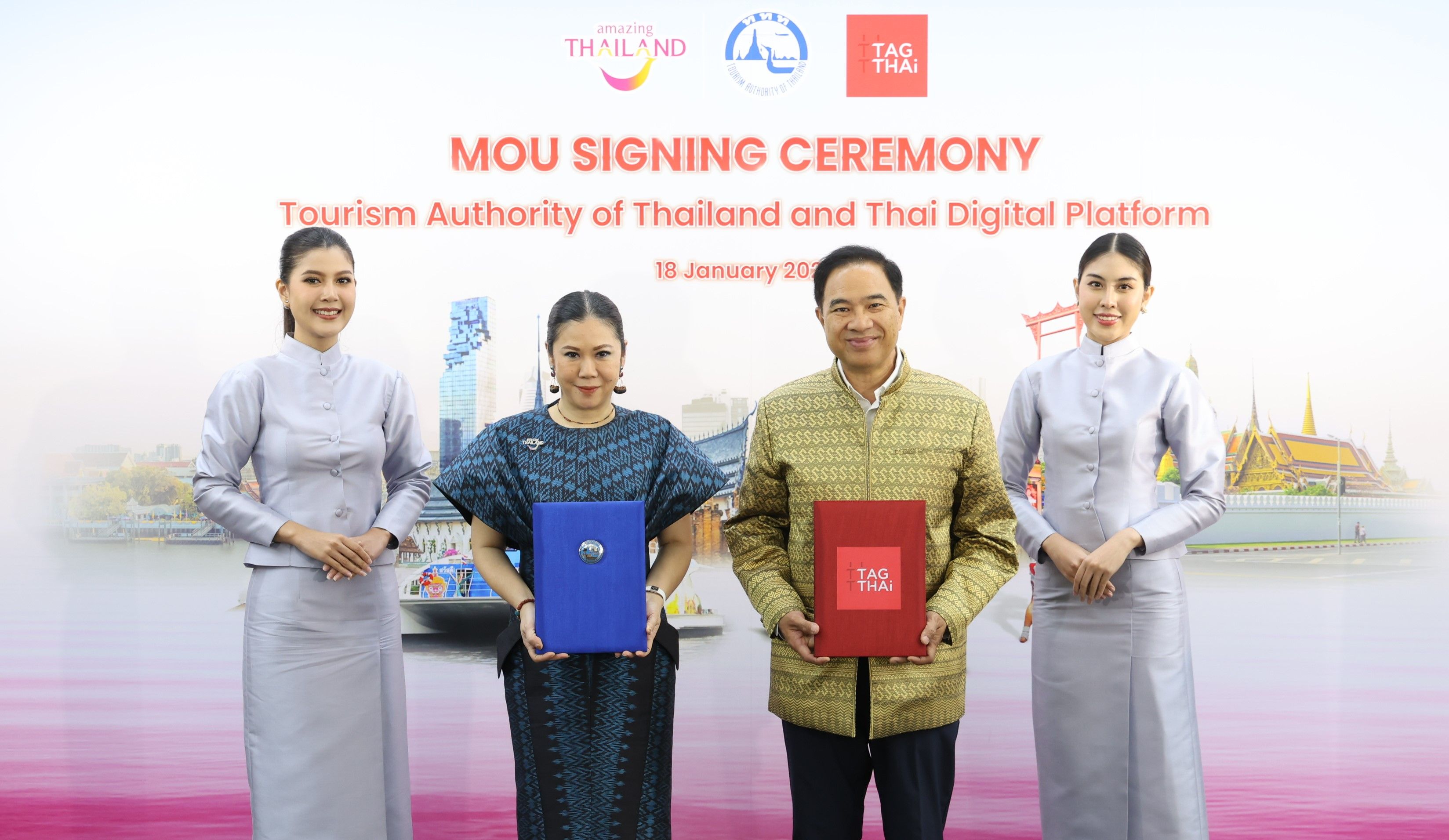 Four officials in traditional Thai attire hold documents at an MOU signing ceremony.