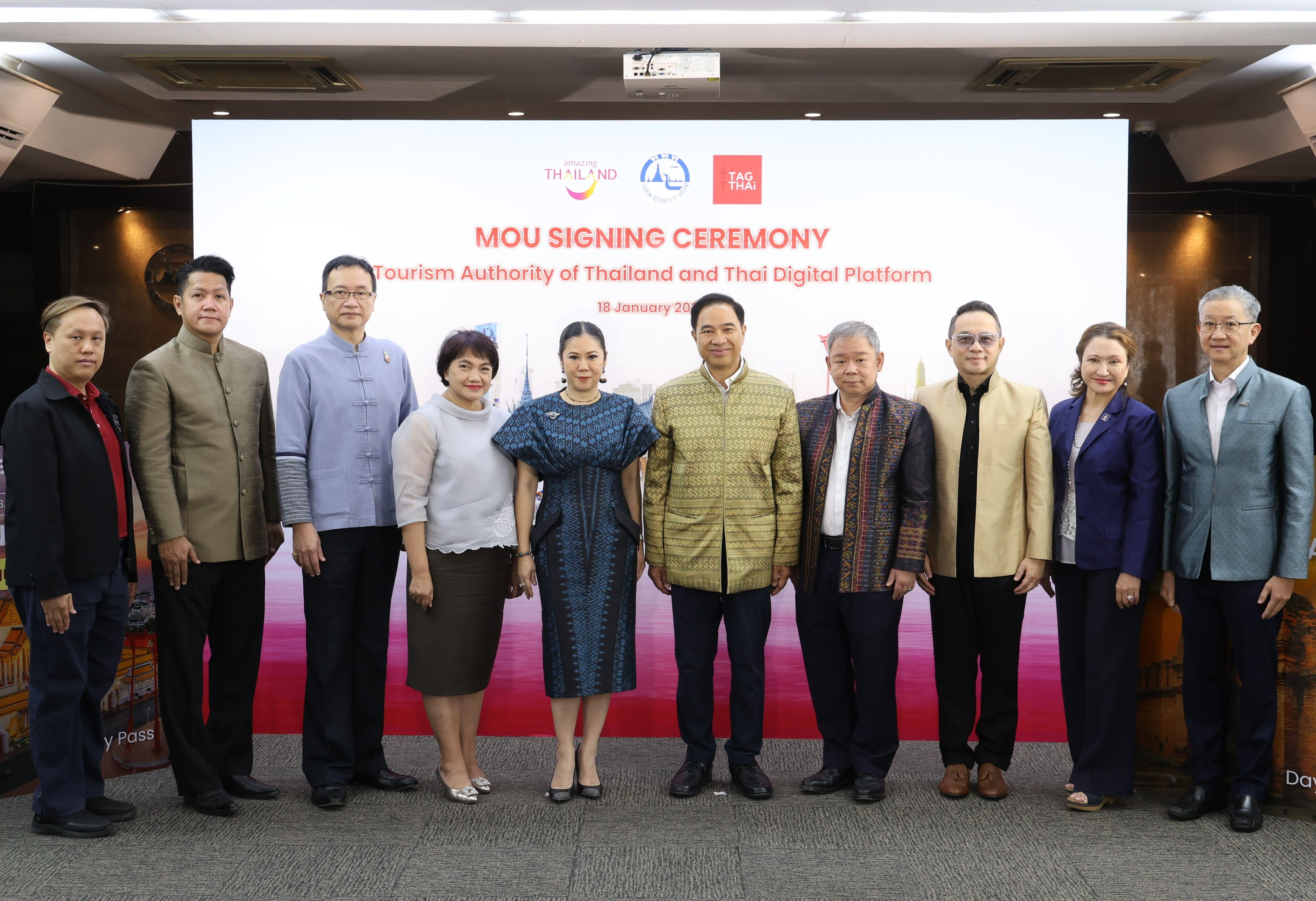 Group of officials in traditional Thai attire at an MOU signing ceremony.