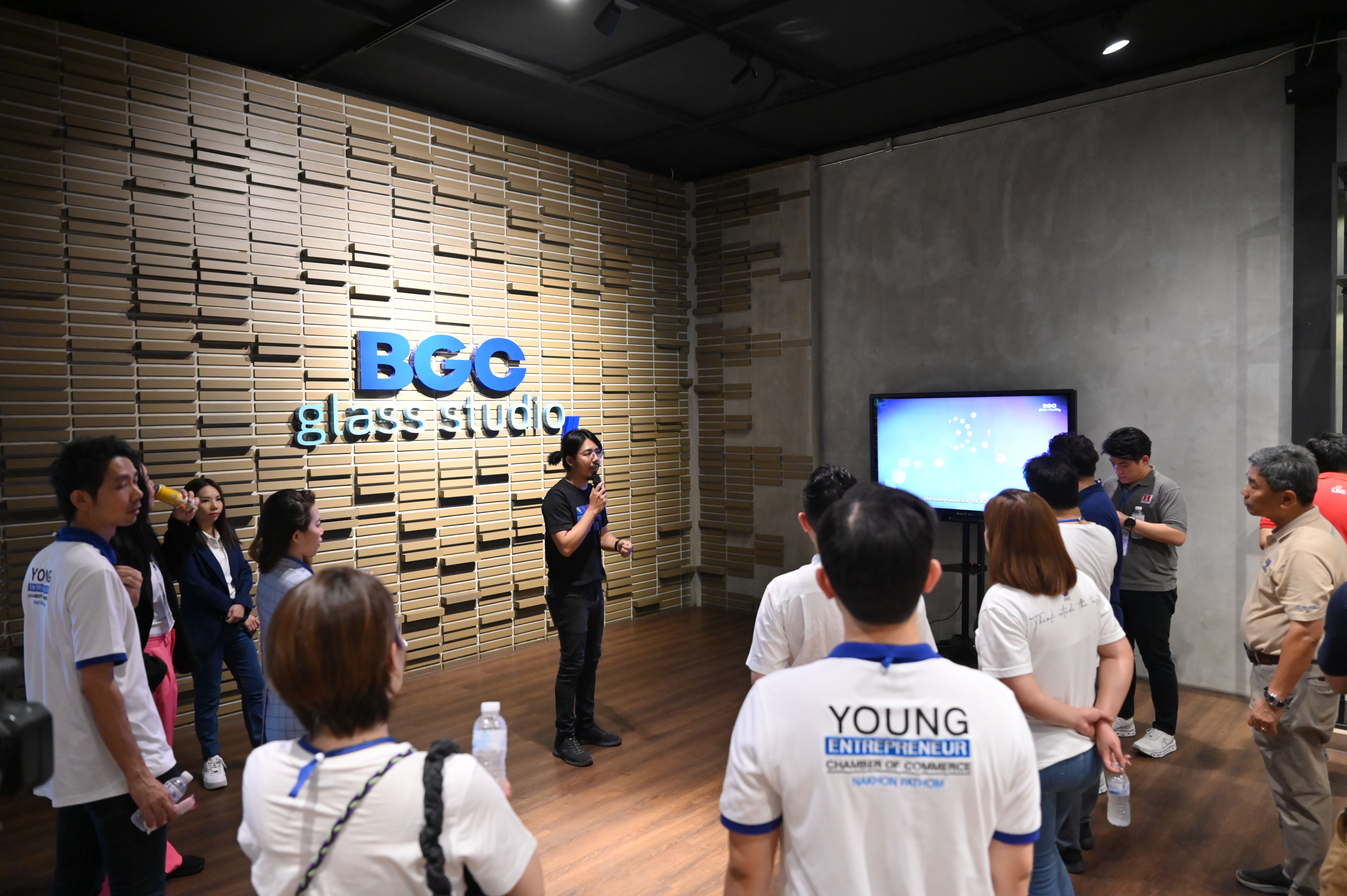 A group of people listen to a presentation at the BGC Glass Studio.