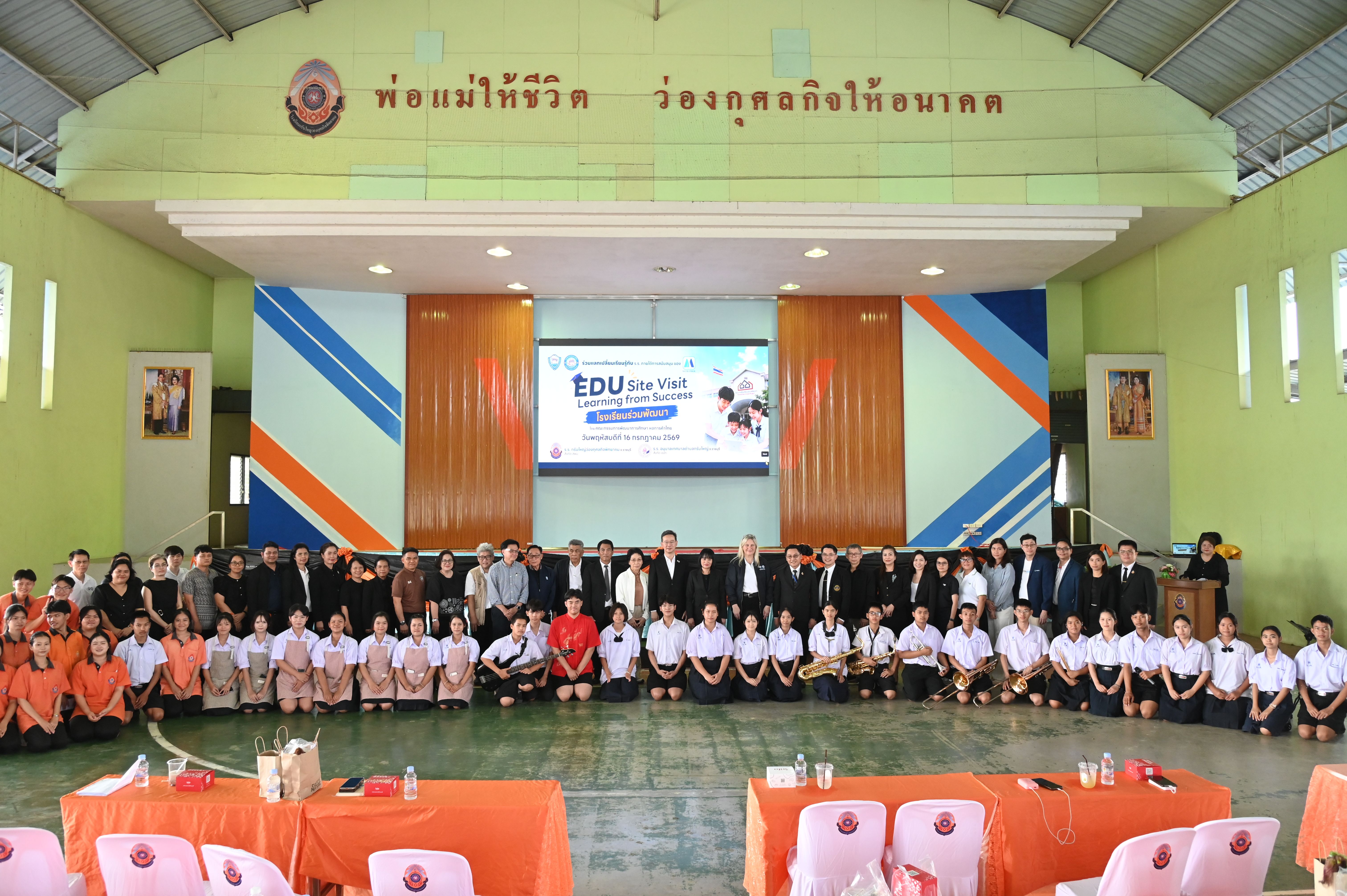 Group of students and adults pose in a school hall with 'TSU Young Talent' banner.