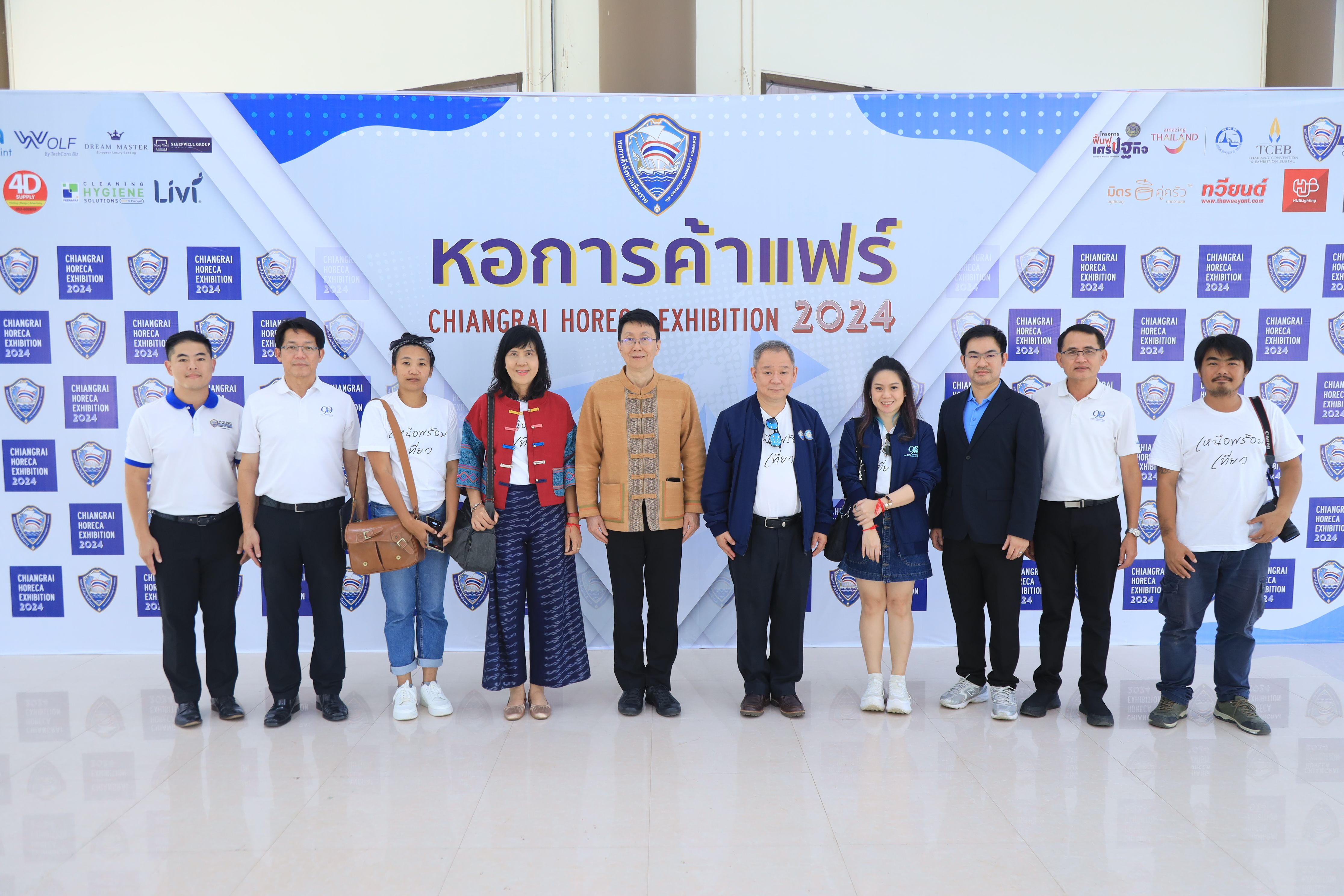 Group of ten people posing at the Chiangmai Horse Exhibition 2024 event banner.