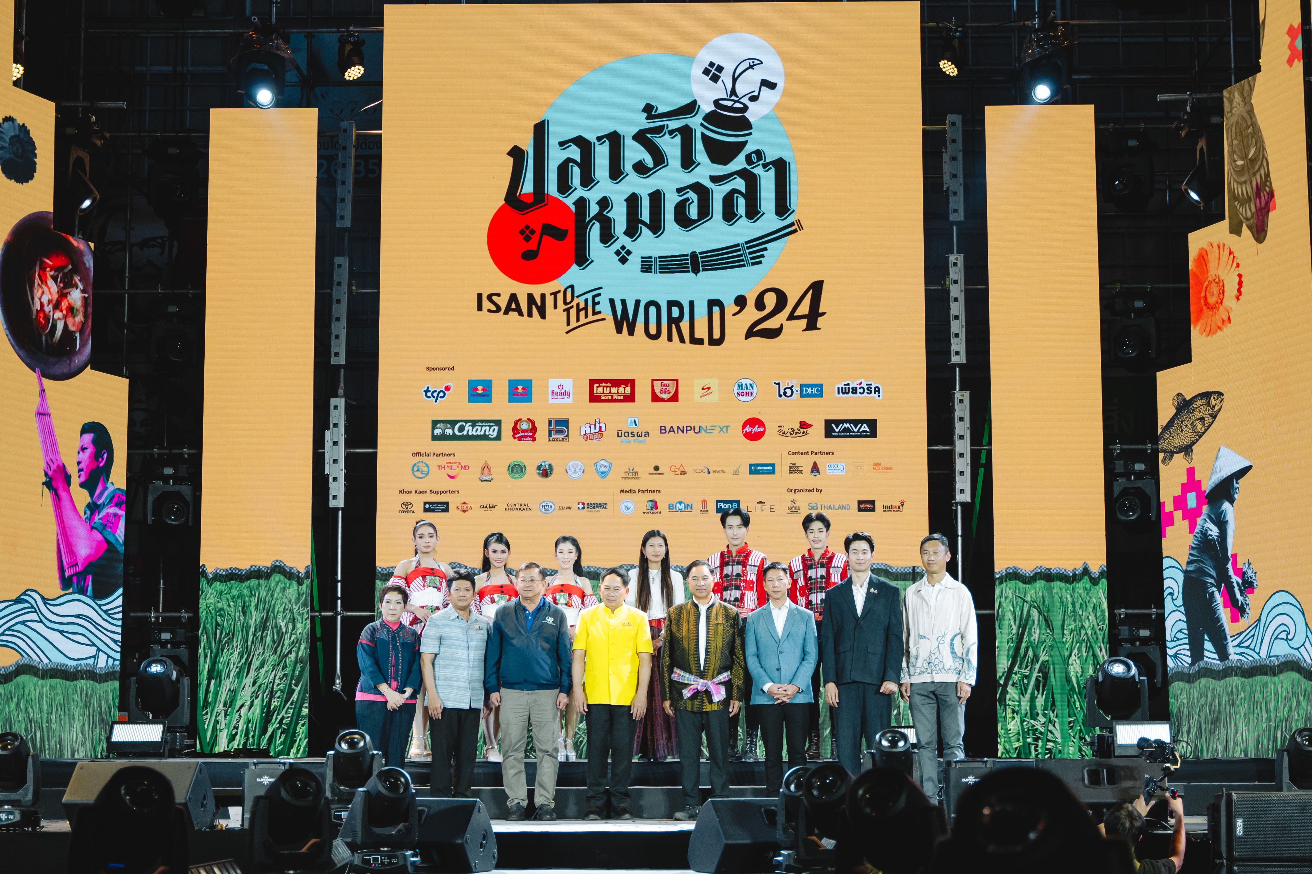 Group of people standing on stage in front of a large screen displaying 'ISAN to the WORLD '24'.