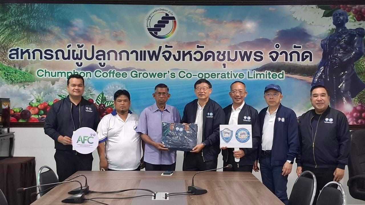 Seven men from Chumphon Coffee Grower's Cooperative exchange documents under their corporate banner.