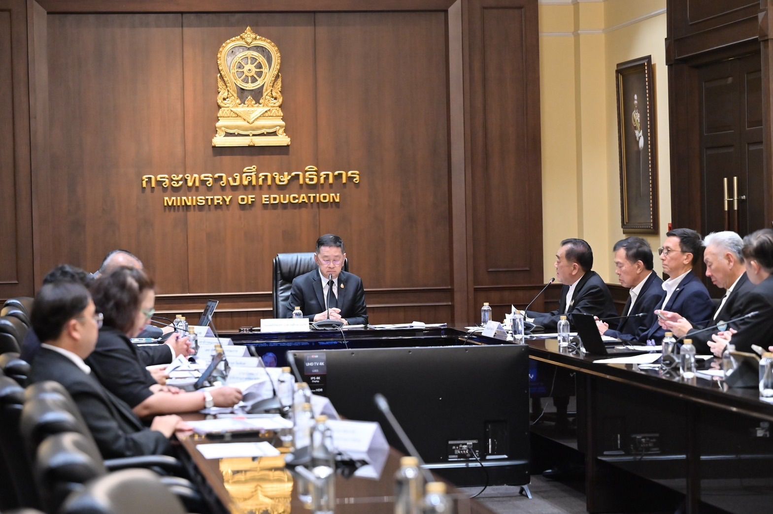 Officials attend a formal meeting at the Ministry of Education conference room.