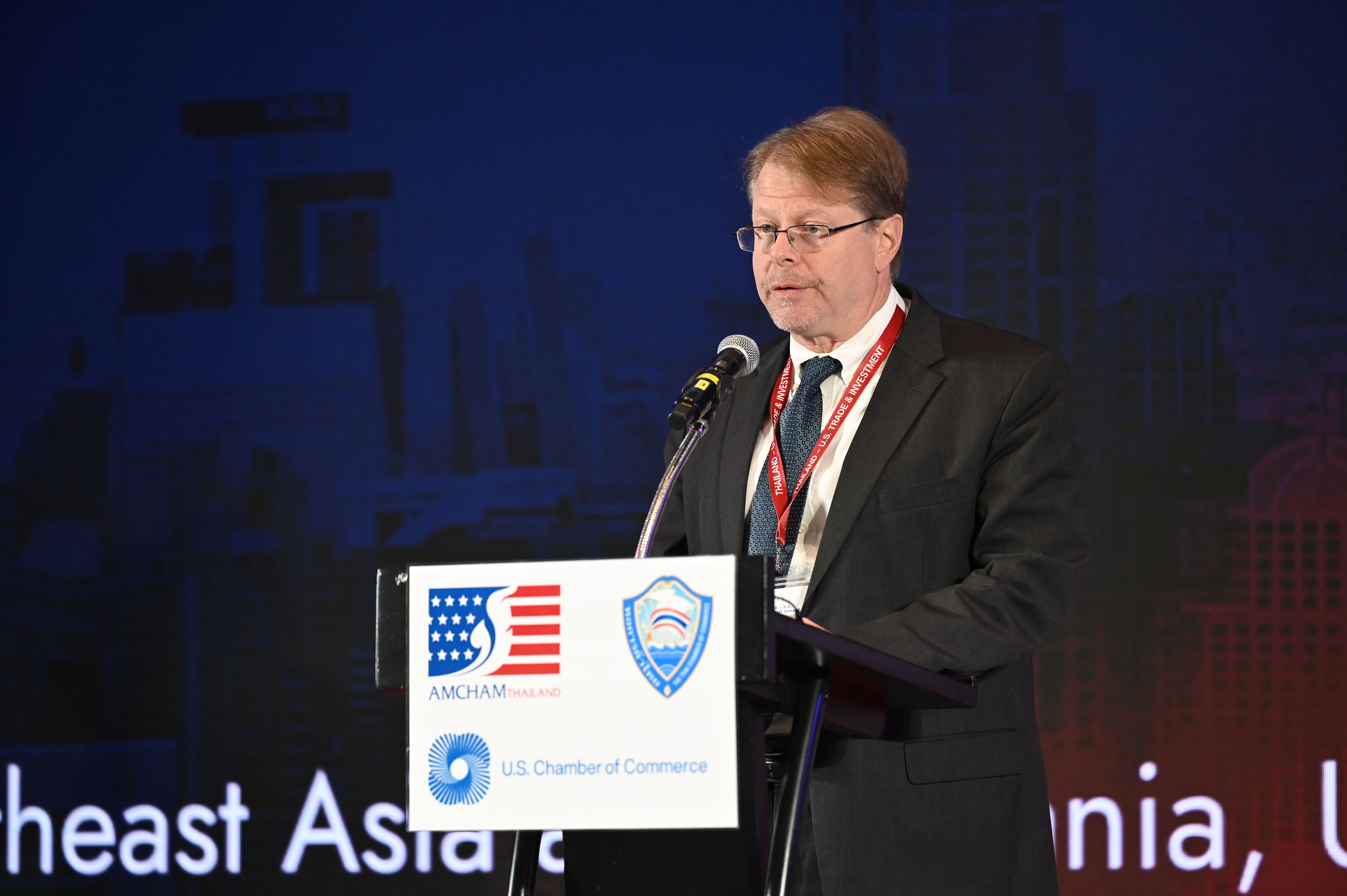 A man in a suit speaks at a podium with U.S. Chamber of Commerce logos visible.