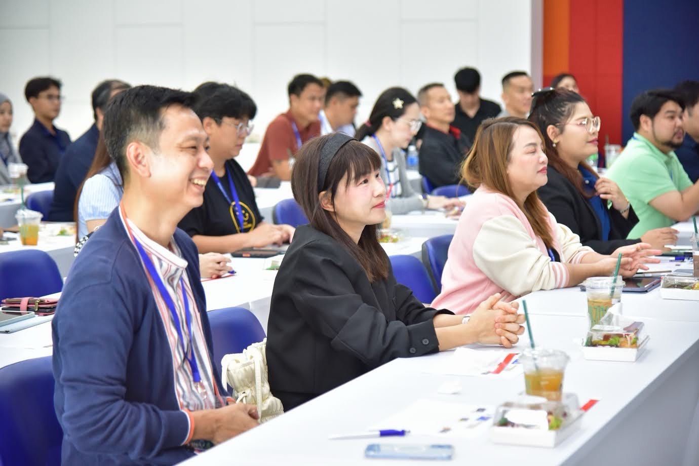A diverse group of attendees attentively listening at a professional conference or training session.