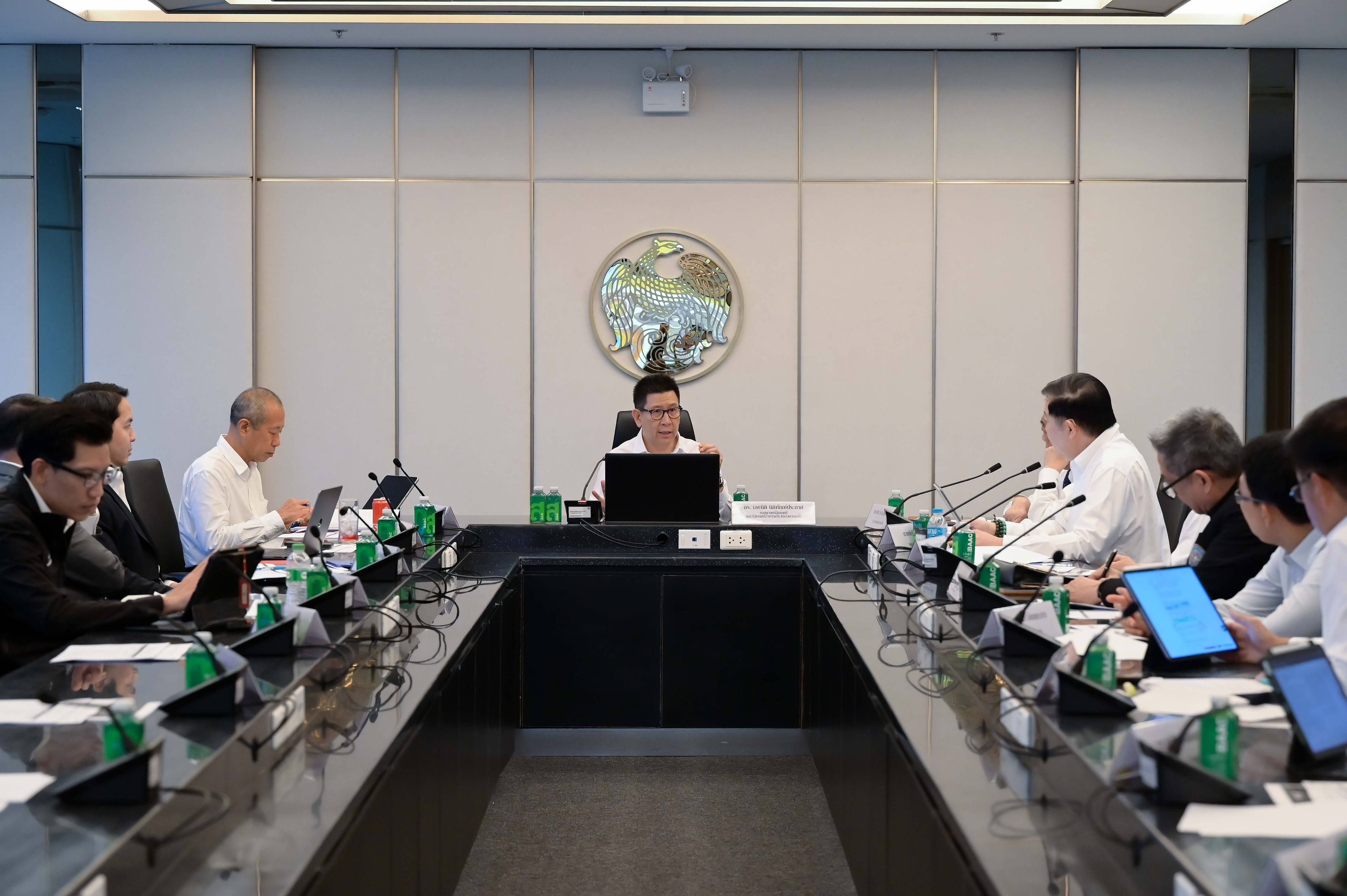 Professionals seated around a long conference table during a formal business meeting.