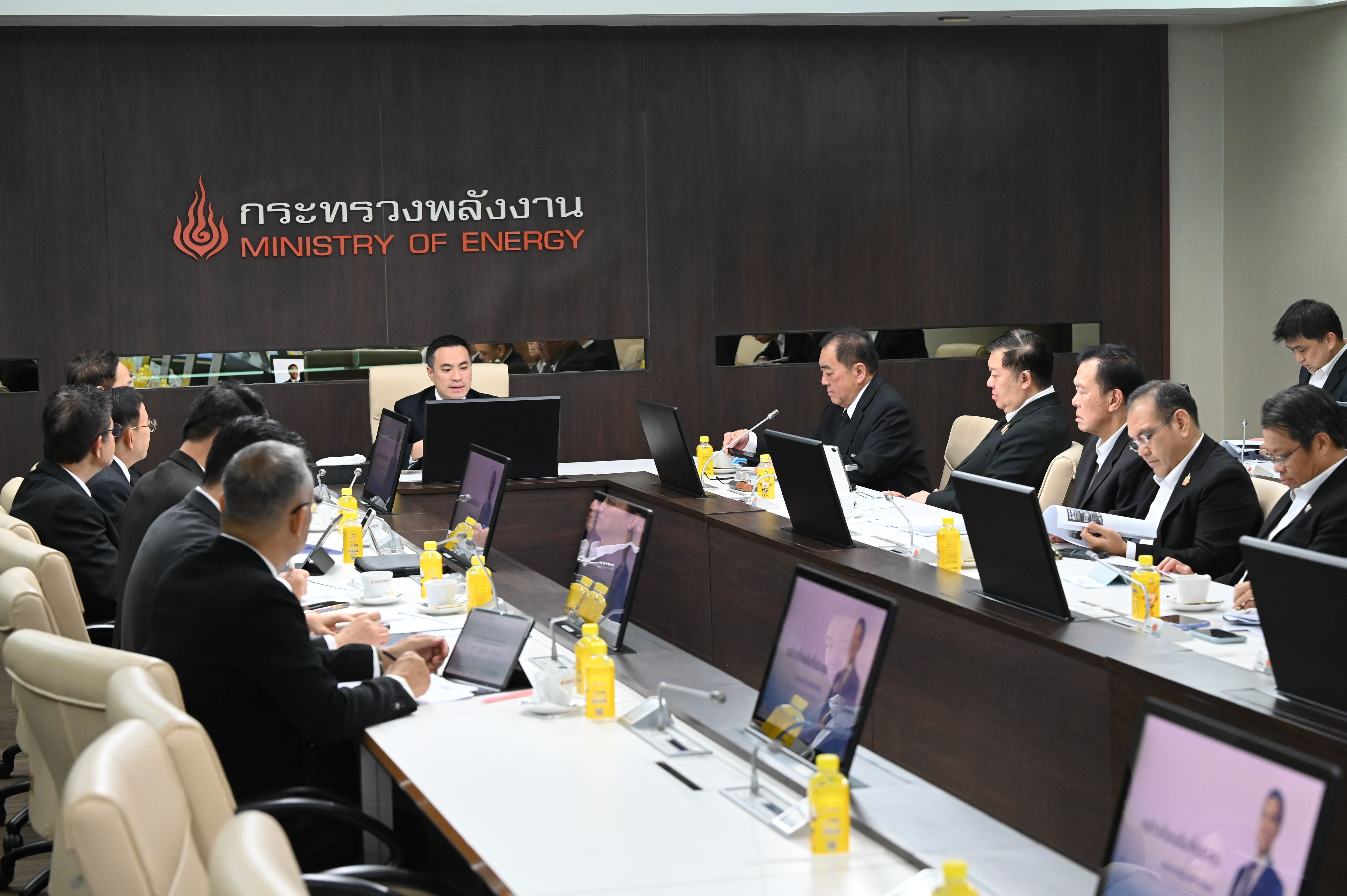 Professionals attend a formal meeting at the Ministry of Energy, Thailand, in a large conference room.