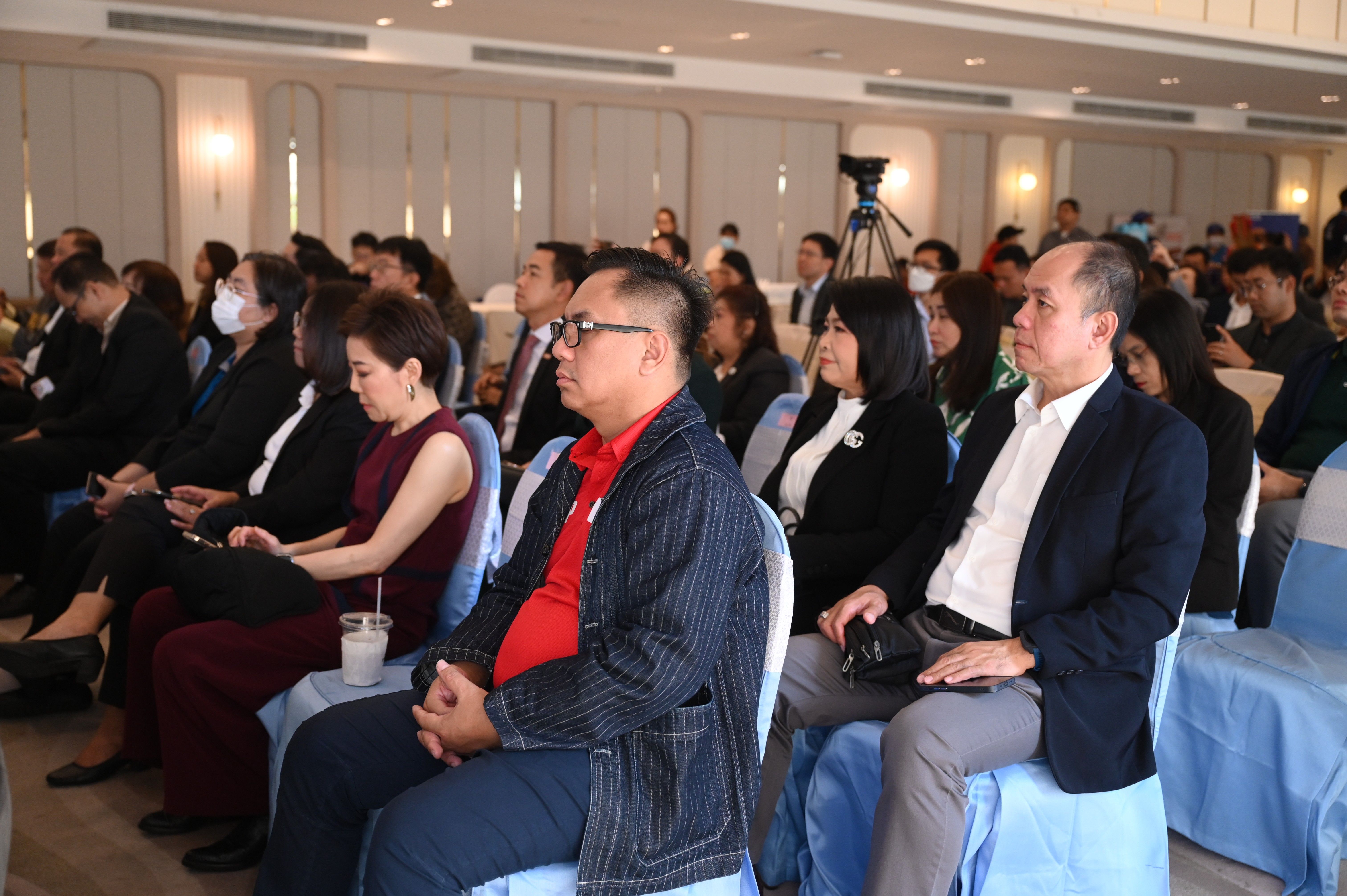 Attendees listen attentively during a corporate event or professional presentation.