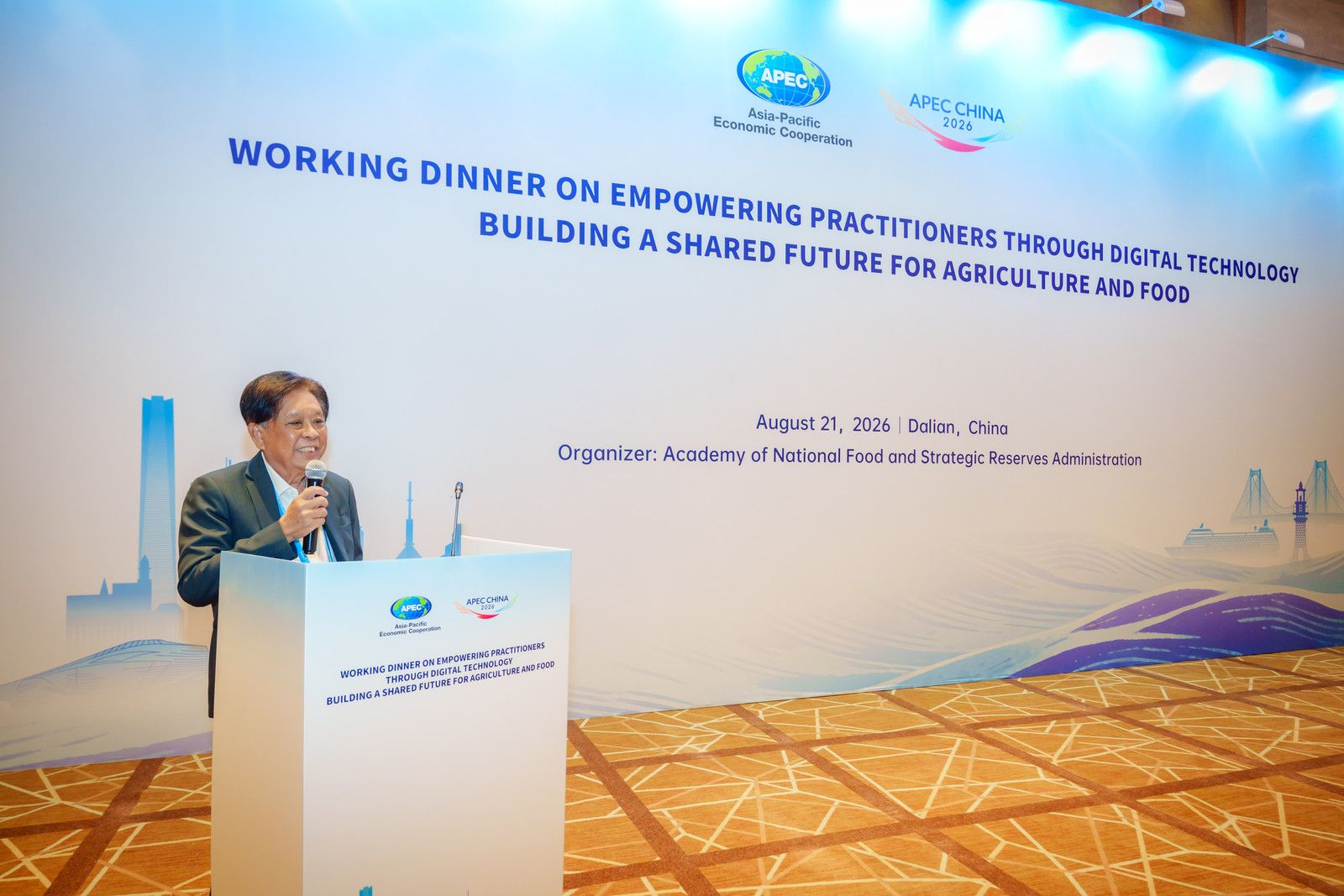 Man speaks at podium during 'Empowering Practitioners Through Digital Technology' dinner.