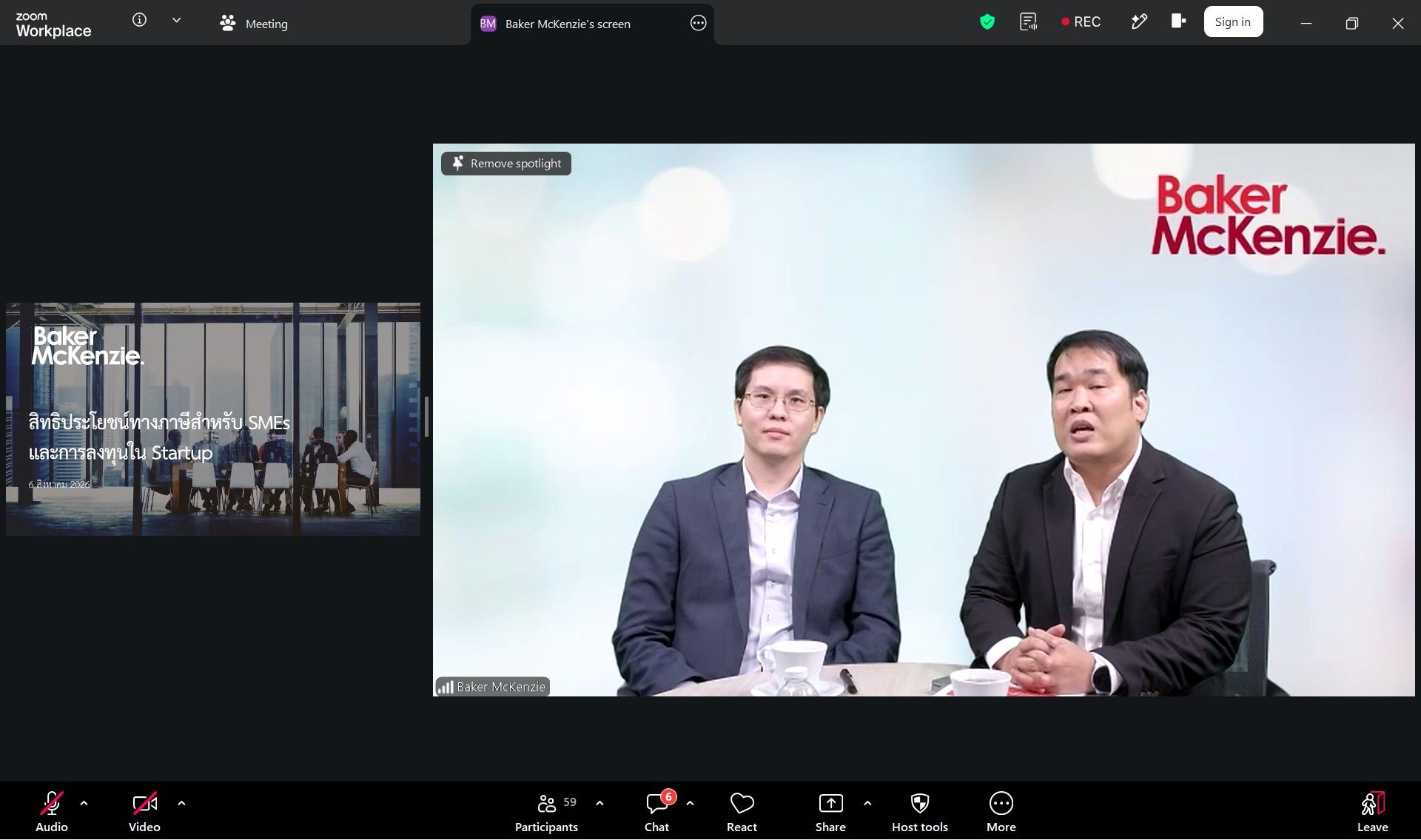 Two professional men present during a virtual meeting with the Baker McKenzie logo.